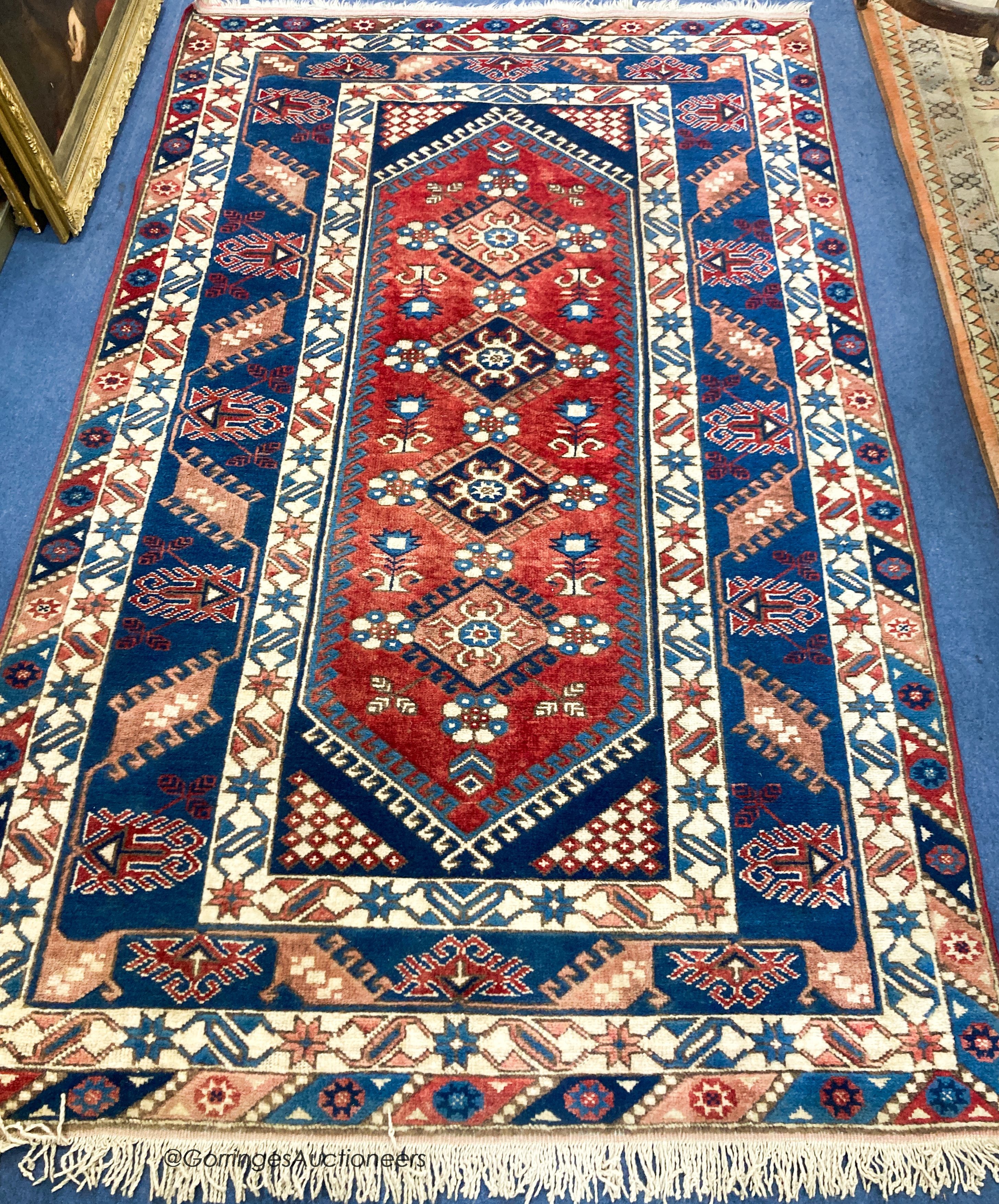 A Caucasian design blue ground rug, 240 x 152cm